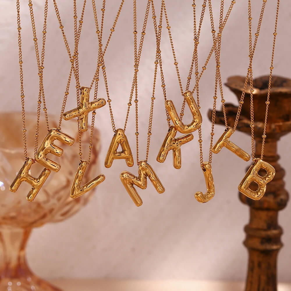 Gold Bubble Letter Necklaces.
