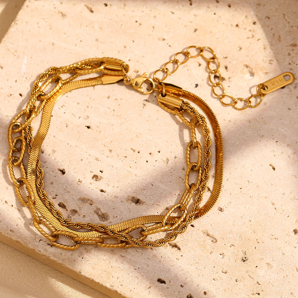 Delicate gold bracelet stack.