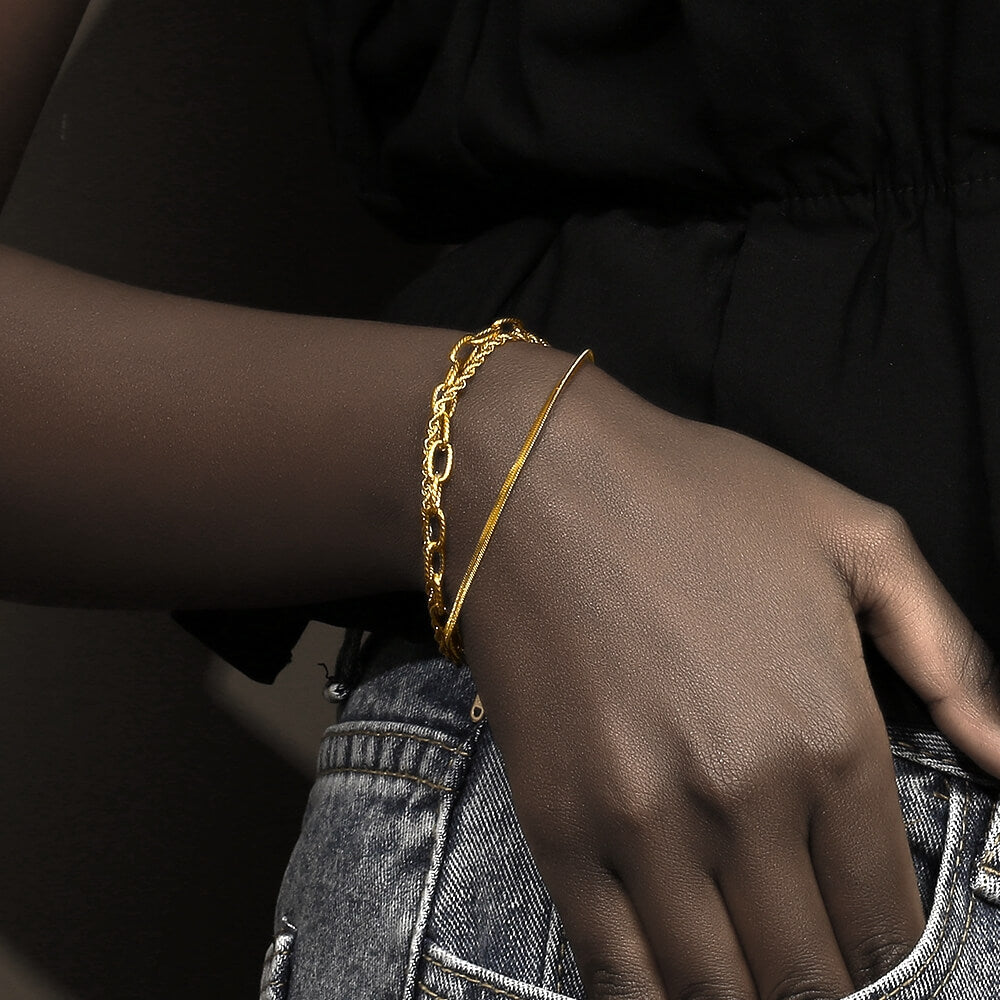 A woman wearing the Multi-Layered Gold Bracelet Stack.