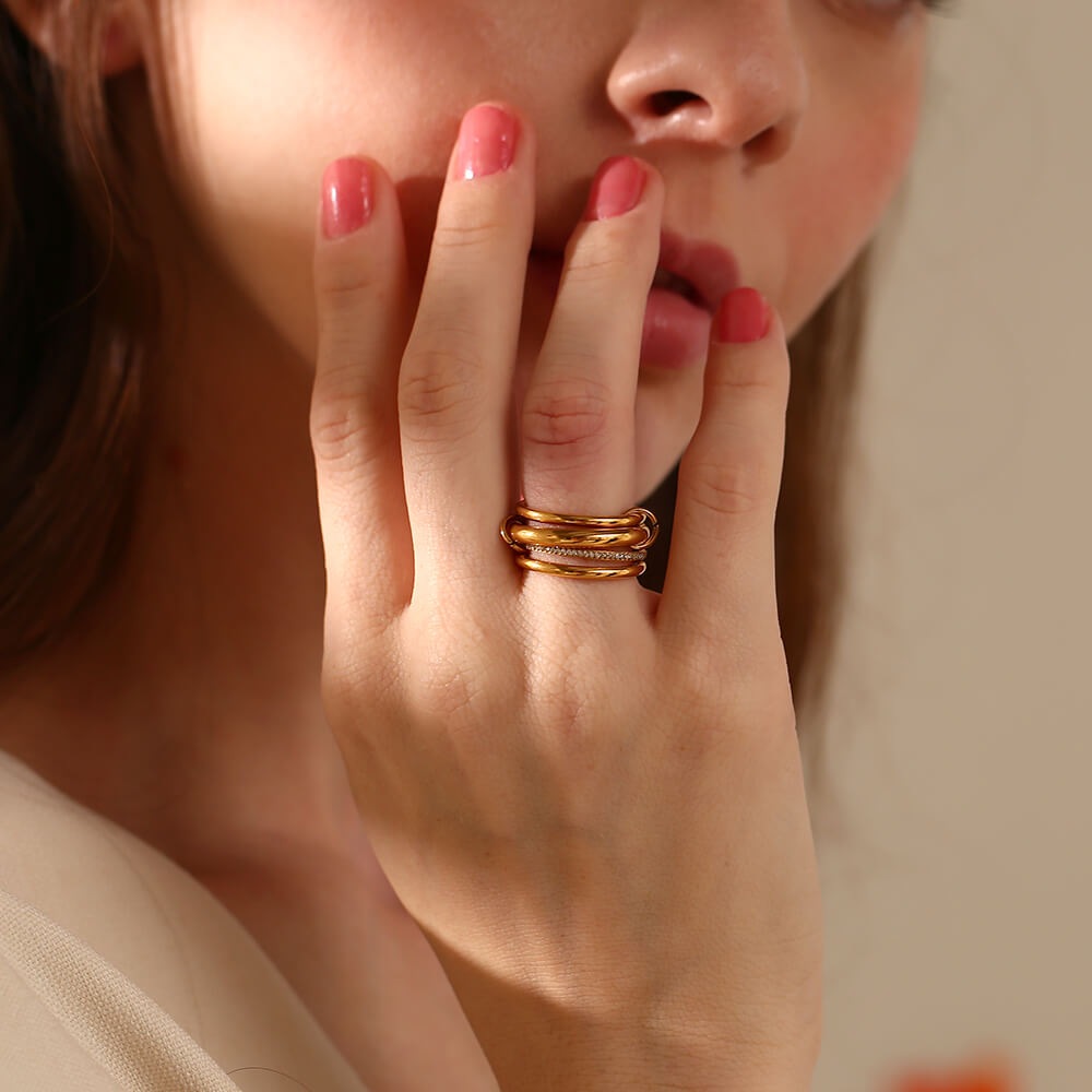 A woman wearing gold stacking rings.