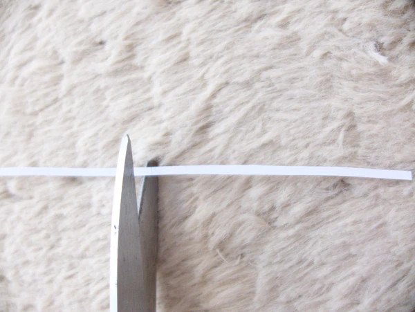 Cutting a strip of paper.