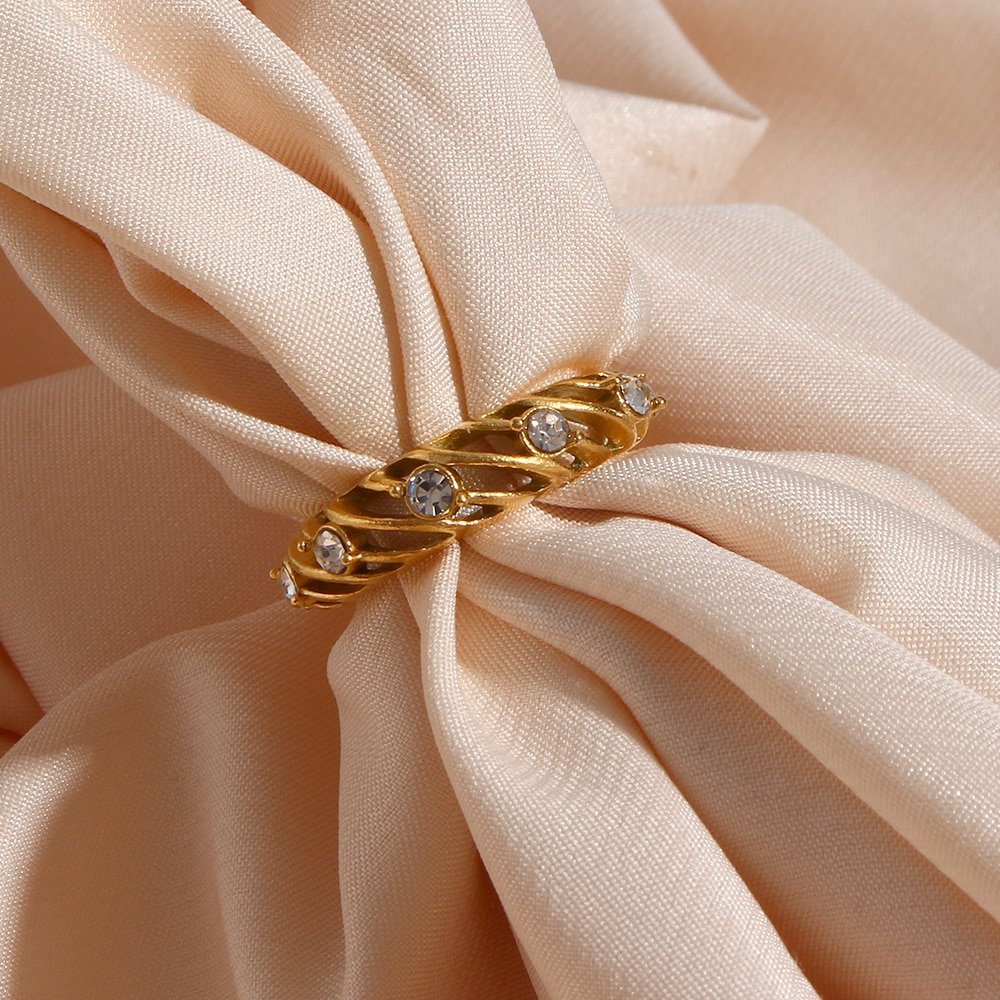 Gold hollow swirl ring with CZ stones.