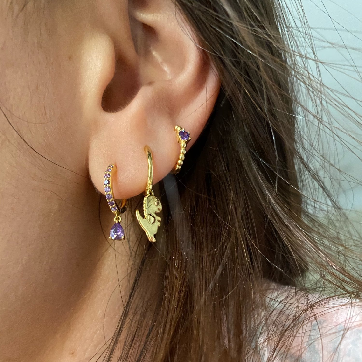 A model wearing the Lilac CZ Teardrop Huggies.