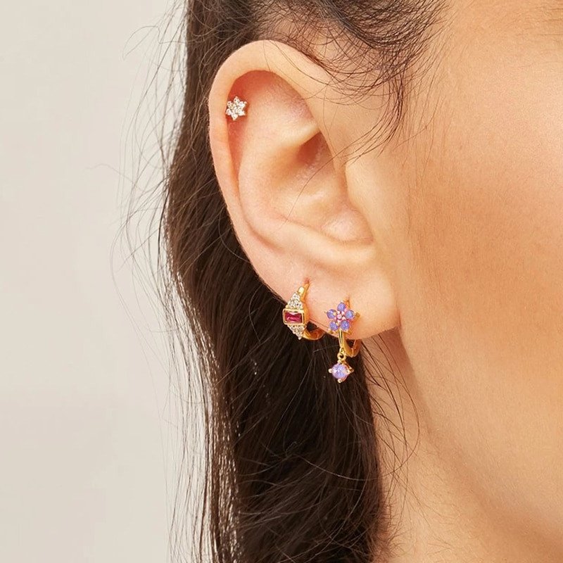 A model wearing the Lilac Flower Drop Huggies.