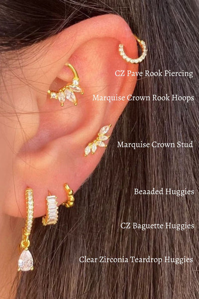 A model wearing multiple gold CZ ear piercings.