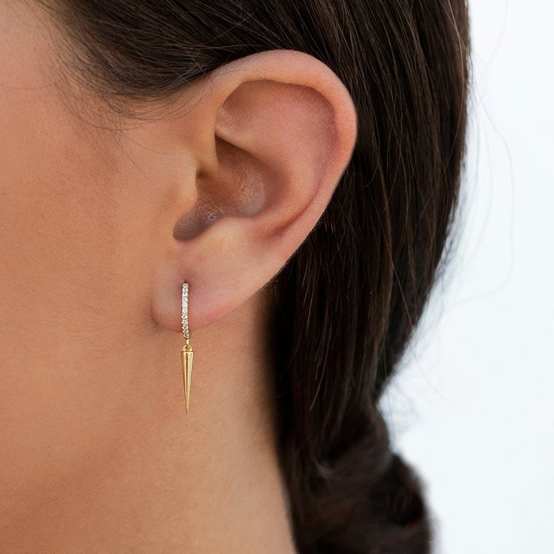 A model wearing the gold Spike CZ Huggies.