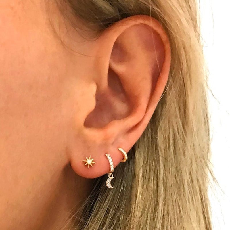 A model wearing gold CZ moon huggies.