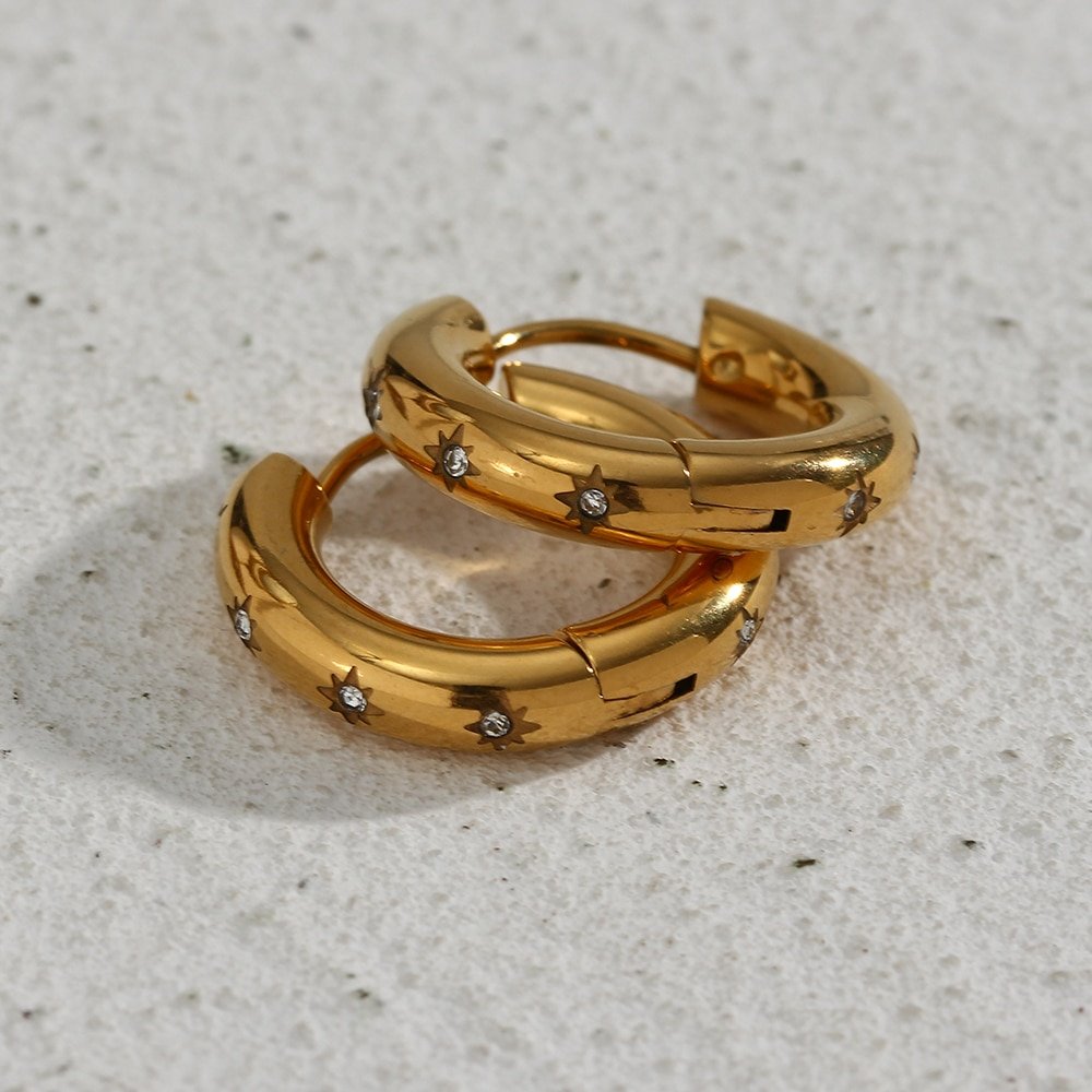 Small gold hoops with CZ stones set into a star engraving.