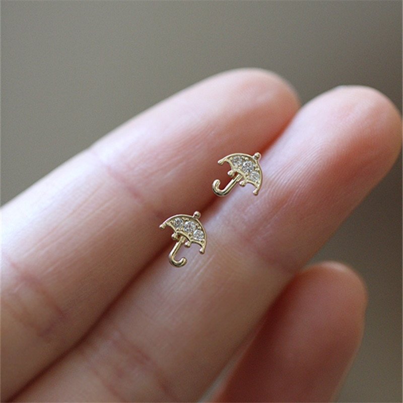 A model holding the Tiny CZ Umbrella Studs.