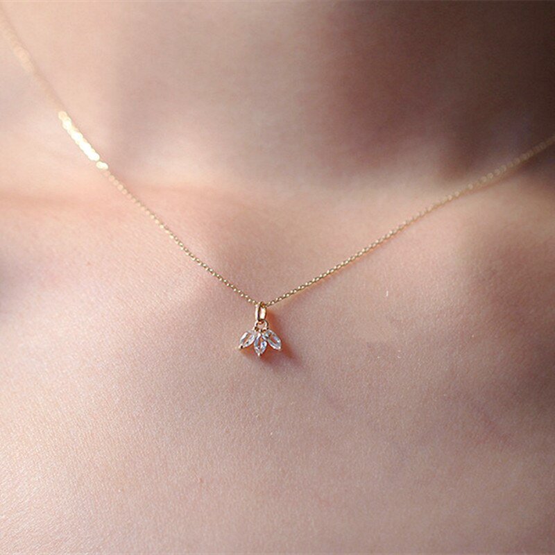 A woman wearing a delicate marquise CZ necklace.